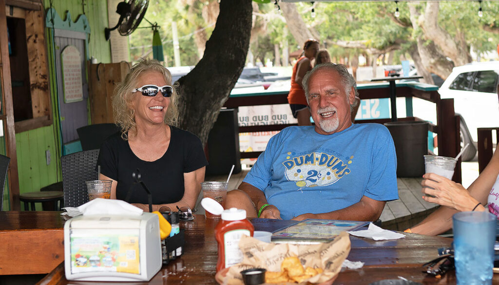 Friends enjoying outdoor waterfront dining at Hidden Treasure in Ponce Inlet